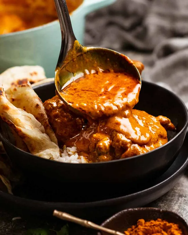Butter masala sauce spooned over rice