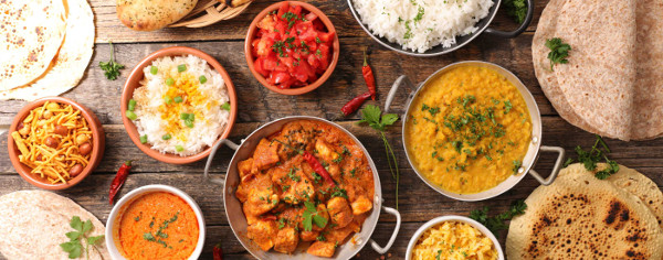 Indian table spread with dhal, rice, curry and bread